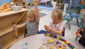 Kids Stringing Beads